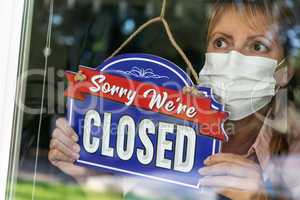 Female Store Owner Wearing Medical Face Mask Turning Sign to Clo