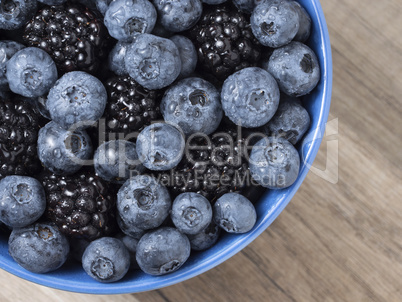 Forest berries (blueberry,bramble) in a ceramic blue  bowl. Top