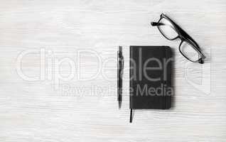 Notepad, glasses, pencil