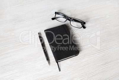 Notebook, glasses and pencil