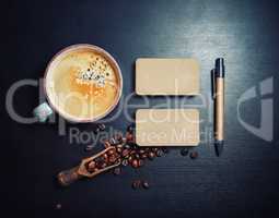 Coffee, business cards, pen
