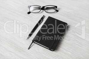 Notepad, glasses, mechanical pencil
