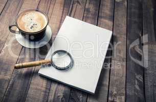 Booklet, magnifier, coffee cup