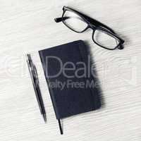 Black notebook, glasses, mechanical pencil