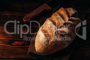 Homemade loaf on cutting board.