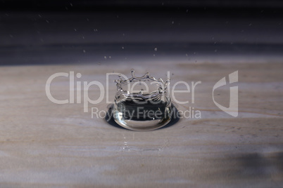 A small water drop fall on water surface