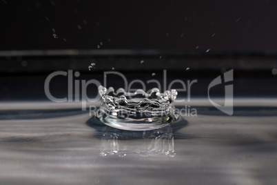 A small water drop fall on water surface