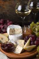 Antipasti. Cheese camembert with fruit and wine