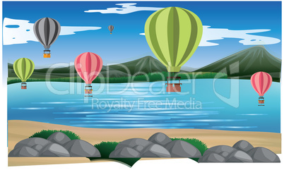 hot air balloons are flying in air on the beach near mountains