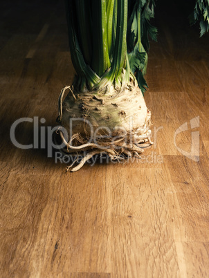 A sandy celeriac on a rustic oak kitchen table