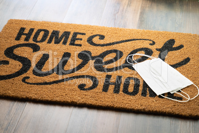 Medical Face Masks Rests on Home Sweet Home Welcome Mat Amidst T