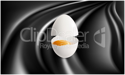 broken egg with yellow yolk on abstract black surface