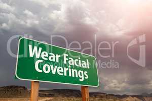 Wear Facial Coverings Green Road Sign Against Ominous Stormy Clo