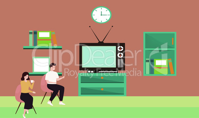couple watching news at home with a cup of tea
