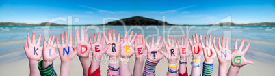 Kids Hands Holding Word Kinderbetreuung Means Child Day Care, Ocean Background