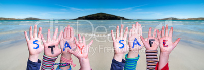 Kids Hands Holding Word Stay Safe, Ocean Background