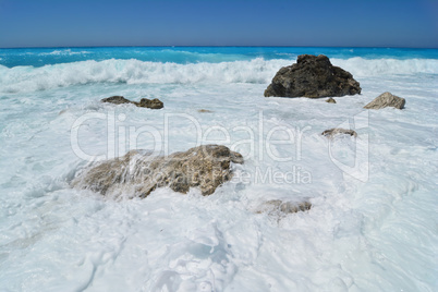 A large carpet of sea foam over stones on Kathisma beach