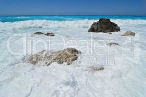 A large carpet of sea foam over stones on Kathisma beach