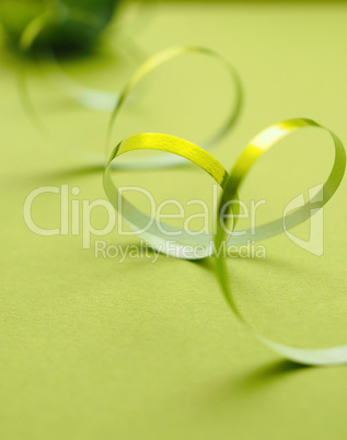 Shiny green ribbon on a green background