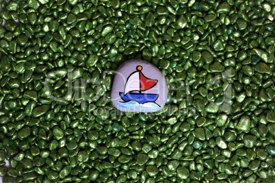 painted stone with the image of a sailing boat