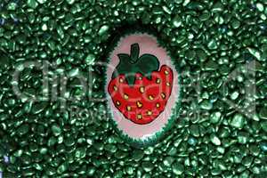 Funny painted stone depicting ripe red strawberries