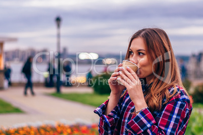 Beautiful young woman drinking coffee