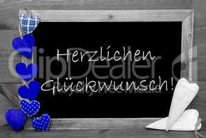 Balckboard With Blue Heart Decoration, Text Glueckwunsch Means Congratulations