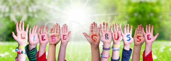 Children Hands Building Word Liebe Gruesse Means Best Wishes, Grass Meadow