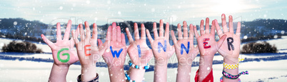 Children Hands Building Word Gewinner Means Winner, Snowy Winter Background