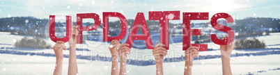 People Hands Holding Word Updates, Snowy Winter Background