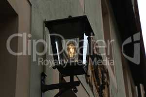 Old street lamps illuminate the way for passersby