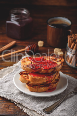 Stack of french toasts with berry syrup