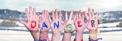 Children Hands Building Word Danger, Snowy Winter Background