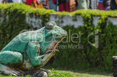 green frog statue at a temple