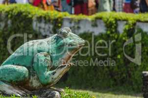 green frog statue at a temple