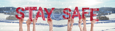 People Hands Holding Word Stay Safe, Snowy Winter Background