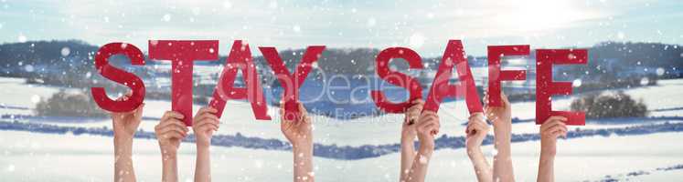 People Hands Holding Word Stay Safe, Snowy Winter Background