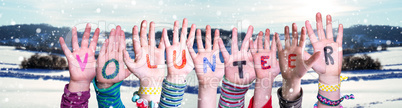 Children Hands Building Word Volunteer, Snowy Winter Background