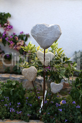 Decorative hearts of stones and metal in the garden