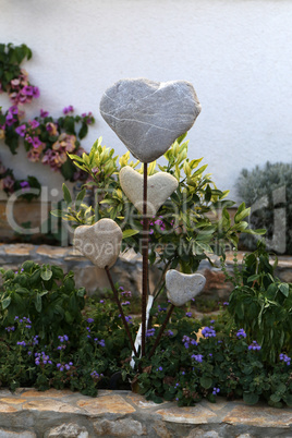 Decorative hearts of stones and metal in the garden