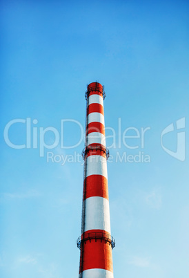 Factory chimney against blue sky