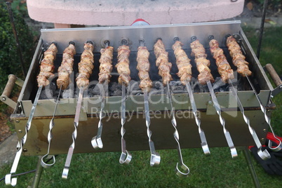 Roasted meat cooked at barbecue with smoke