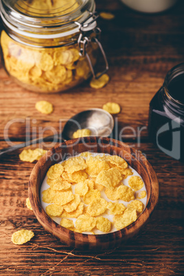Breakfast with corn flakes, milk and jam