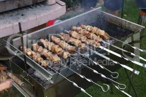 Roasted meat cooked at barbecue with smoke