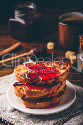 Stack of french toasts with berry syrup