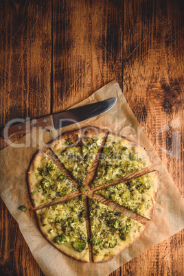 Cooked and sliced broccoli and cheese pizza