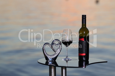 Composition of glasses and wine bottles at sunset