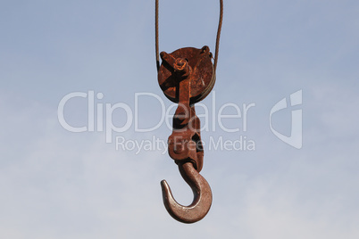 Old rusty hook of a hoisted crane in the port