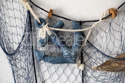 Composition from the fishing net on the wall of the house