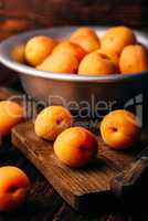 Mellow apricots with knife over cutting board